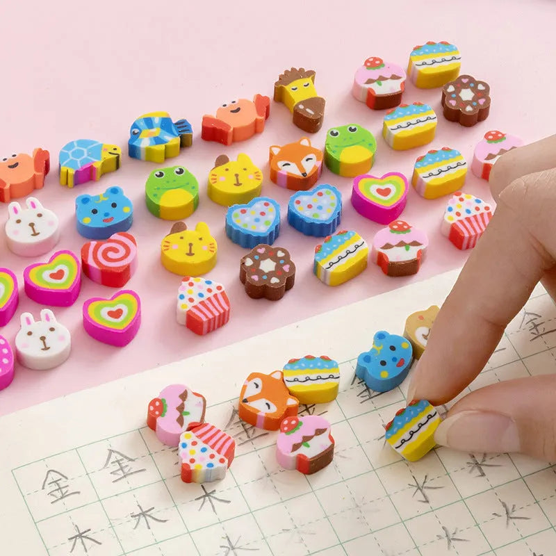 Assortment of 50 colourful mini cartoon erasers in shapes of fruits, animals, and cakes on a white background.