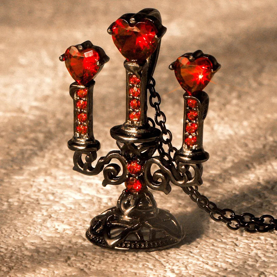 Close-up of a women's retro gothic necklace with a hollow candlestick pendant on a cross chain.