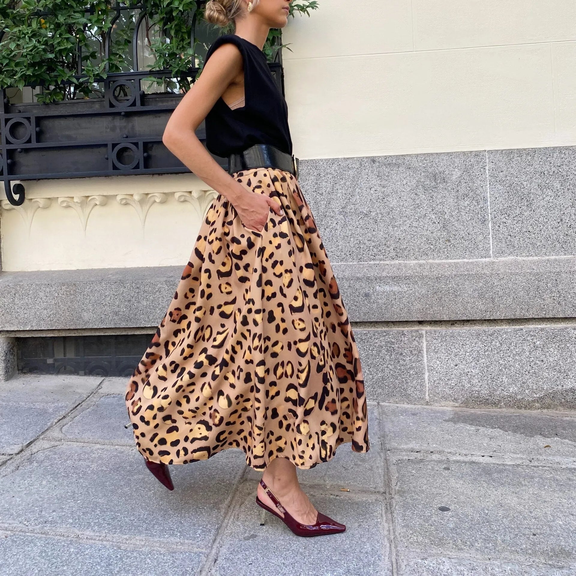 Women's long brown leopard print A-line skirt with a big hem.