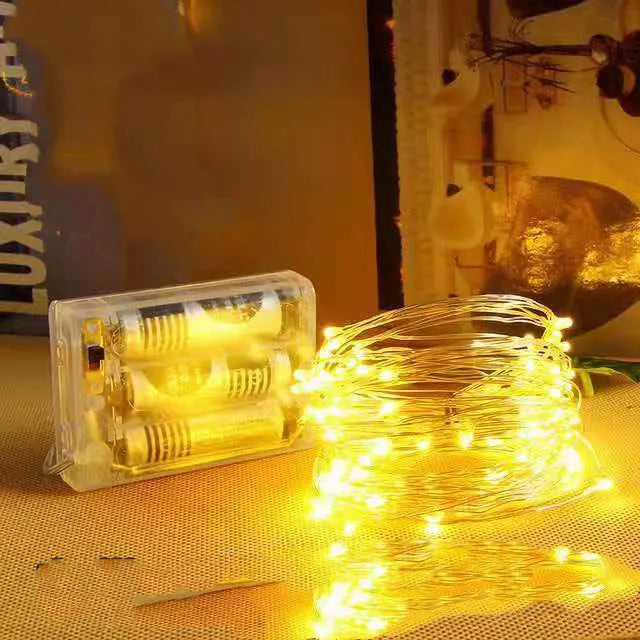 Copper wire decorative string light with 120 bulbs on a 12-metre cable, showing battery box and colour options.