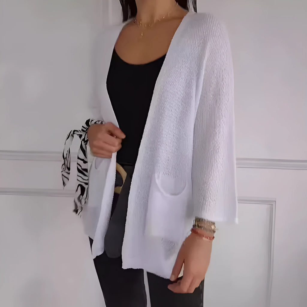 Women's army green waffle knit cardigan coat with nine-quarter length sleeves and pockets.