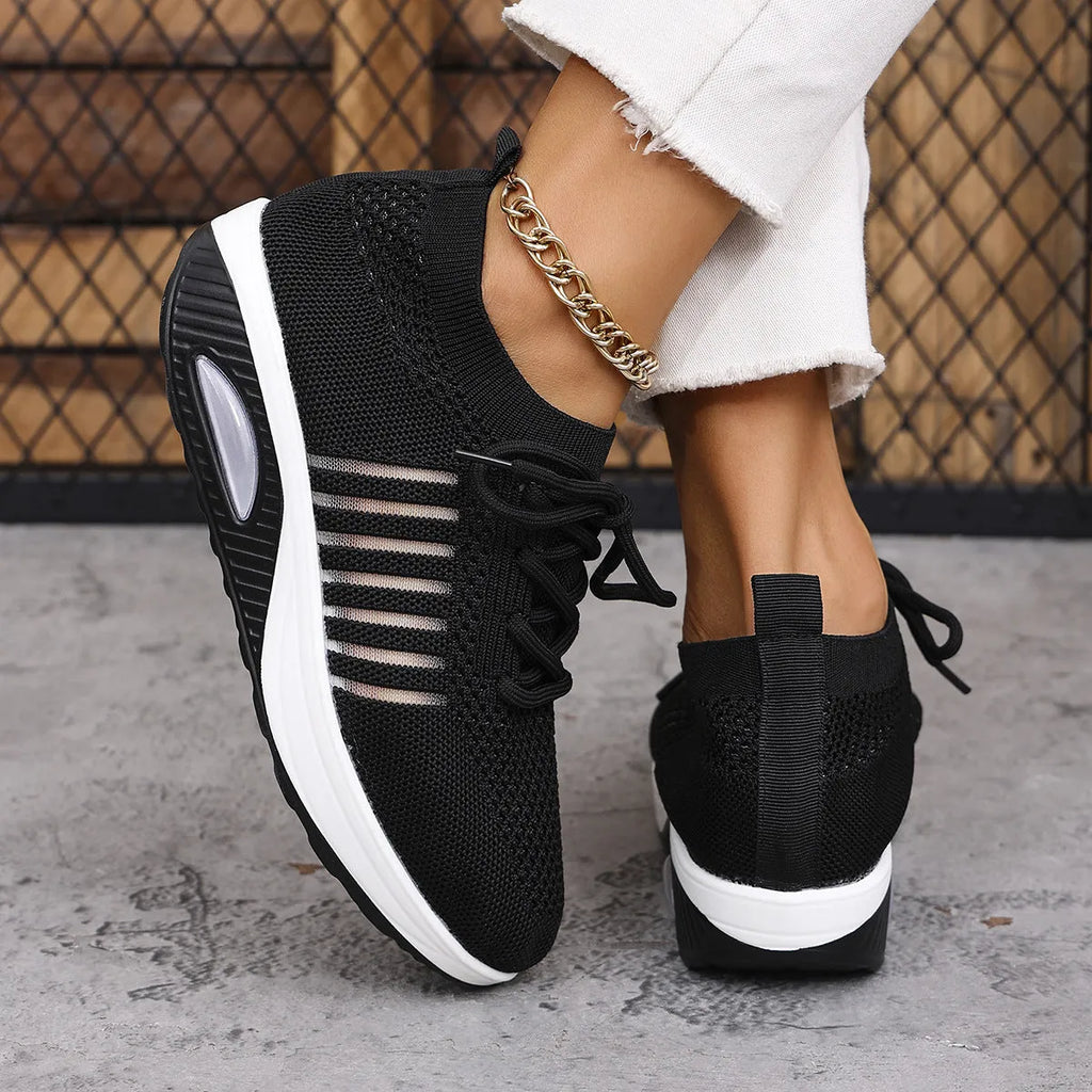 Women's lace-up slip-on wedge sports shoes in black with mesh upper and mid heel height increase