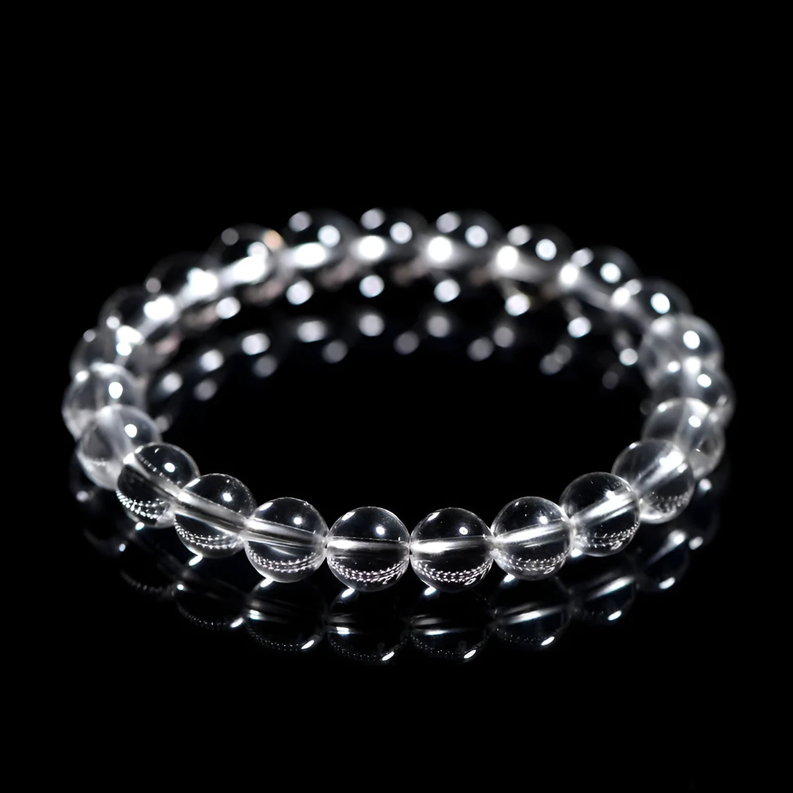 Natural white crystal bracelet with round beads, showing unisex geometry design on a wrist.