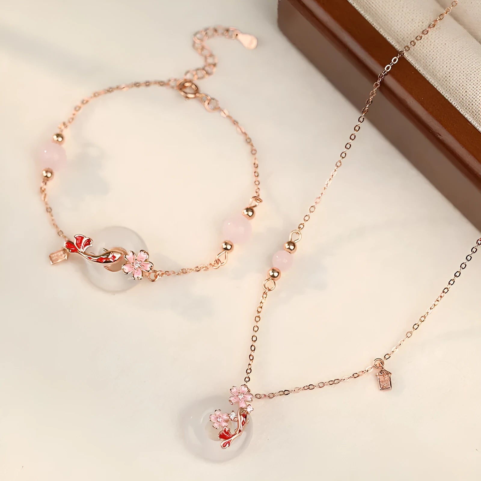S925 sterling silver bracelet with white chalcedony beads and a gold-toned koi fish charm.