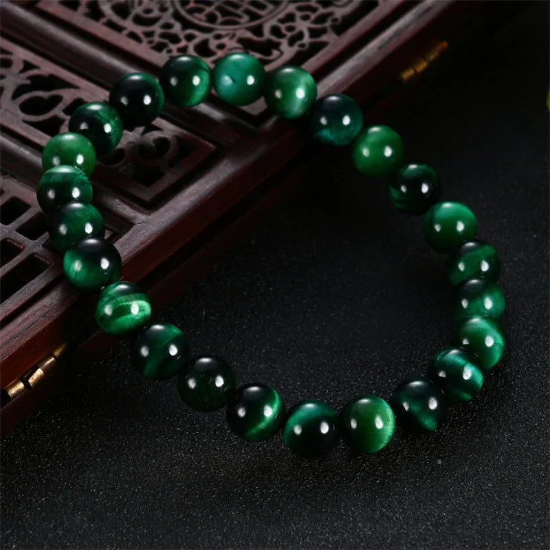 Green Tiger Eye stone bracelet with polished geometric beads on a wrist
