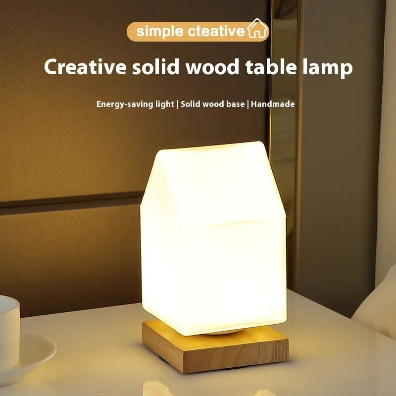 White Nordic solid wood USB table lamp with touch dimming in cube shape on a wooden table.