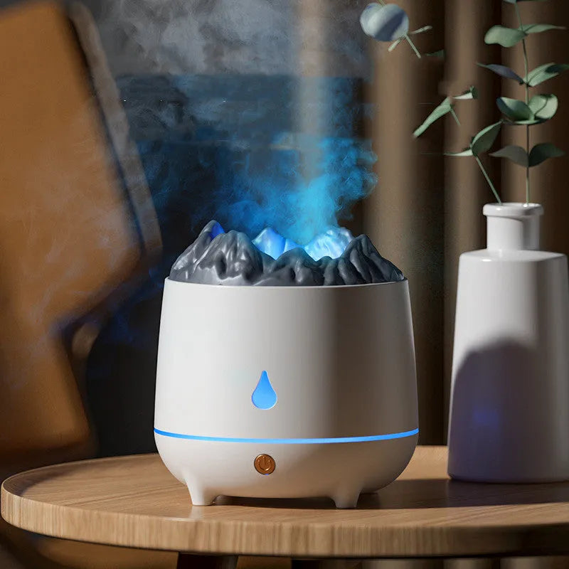 White volcano-shaped humidifier and aromatherapy diffuser on a table with USB cable.