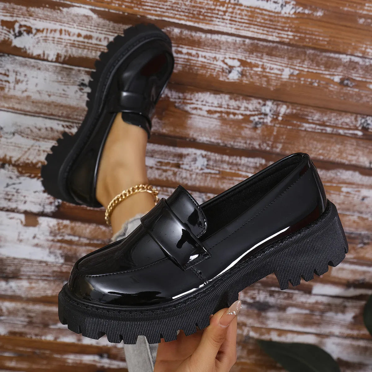 Black plus size women's loafers with a chunky platform heel and slip-on design.