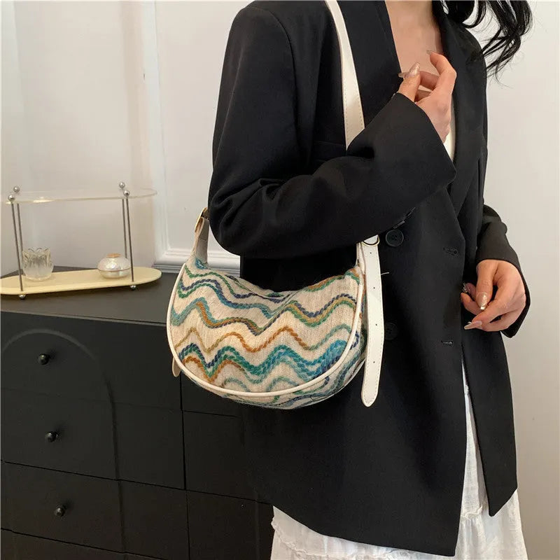 Women's woven straw crossbody bag showing internal phone and document pockets in corrugated brown colour