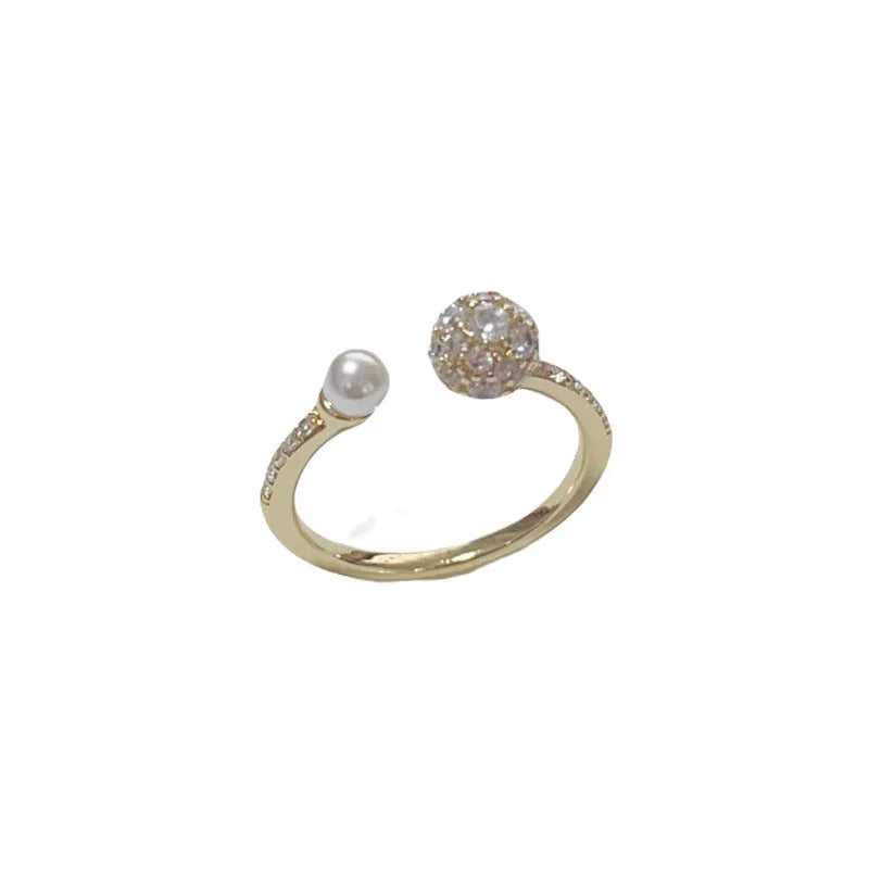 Minimalist open-end ring with round zircon stone on a geometric band in gold tone.