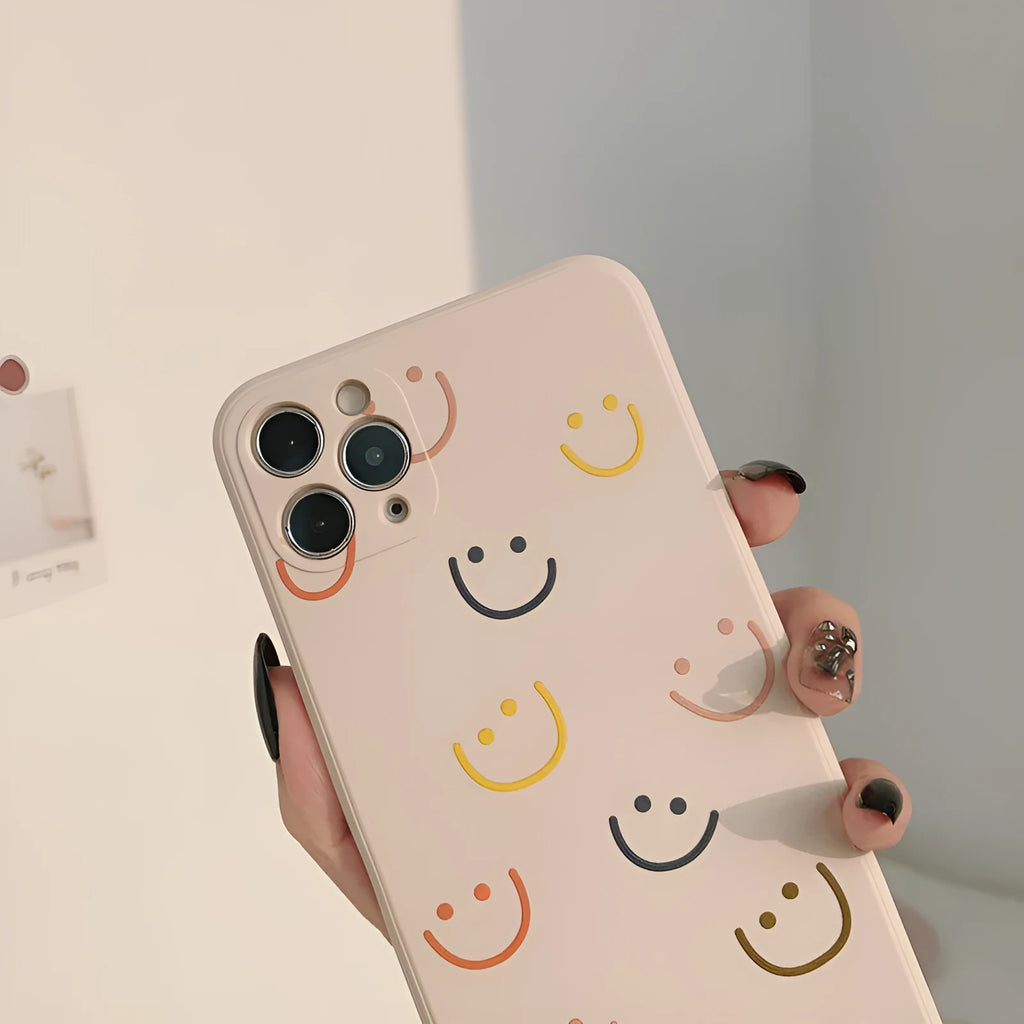 Simple TPU iPhone case with painted smiley face design in three colour options