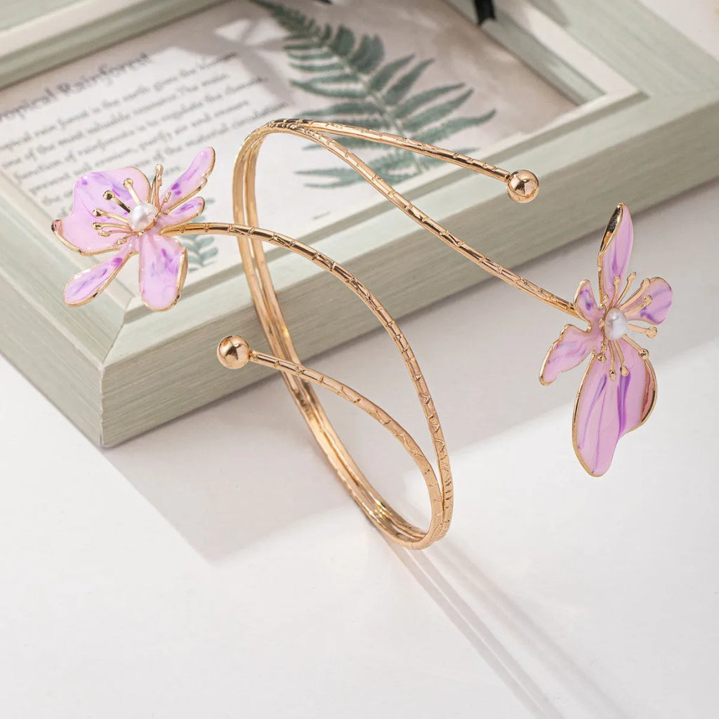 Pink personalised hollow pattern alloy armband open ring bangle on a wrist.