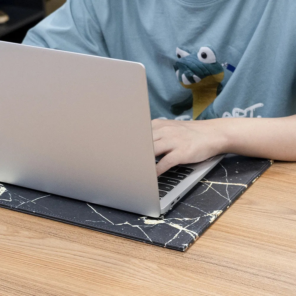 Anti-radiation printing tablet pad in black, gold, blue, and green colour options on a desk.