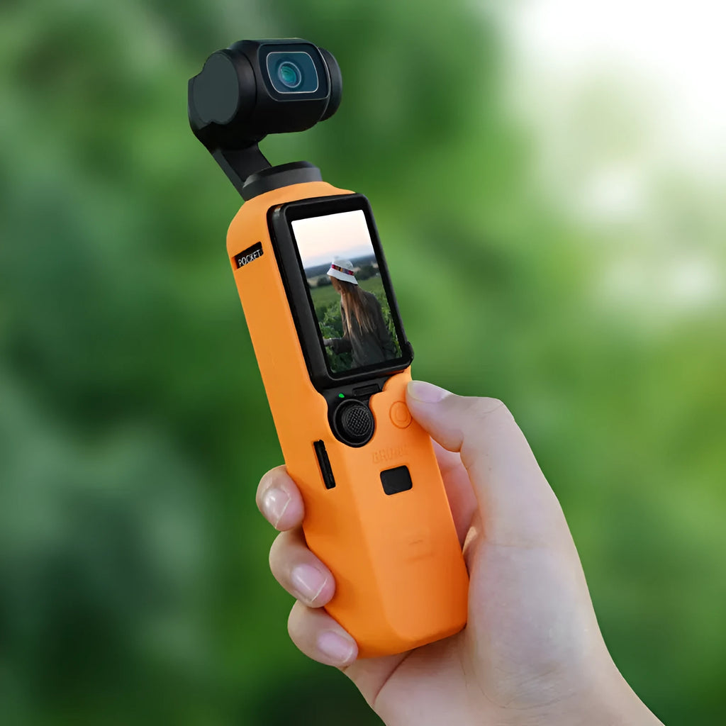 Black silicone protective sleeve cover for a PTZ camera motor body, shown next to red and orange versions.