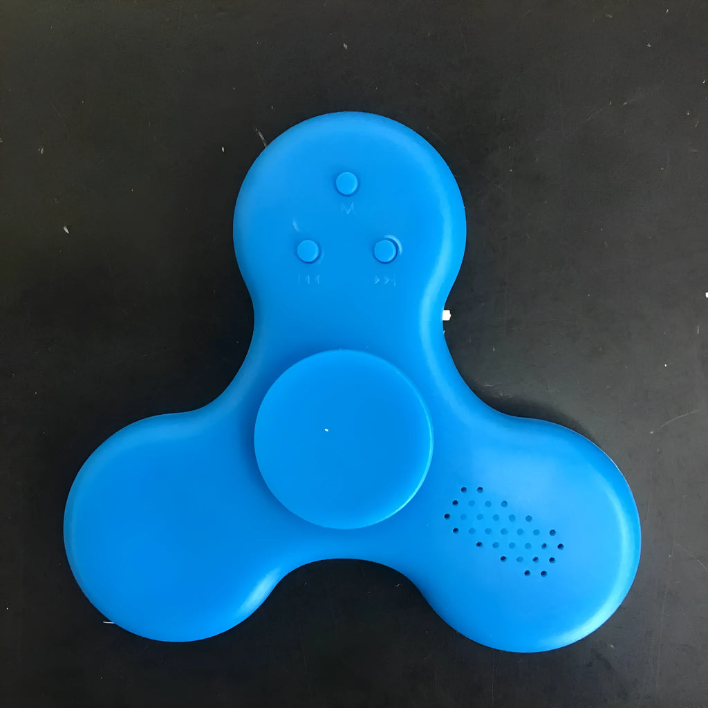 A square blue Bluetooth speaker and MP3 player with an integrated fidget spinner, showing button controls.