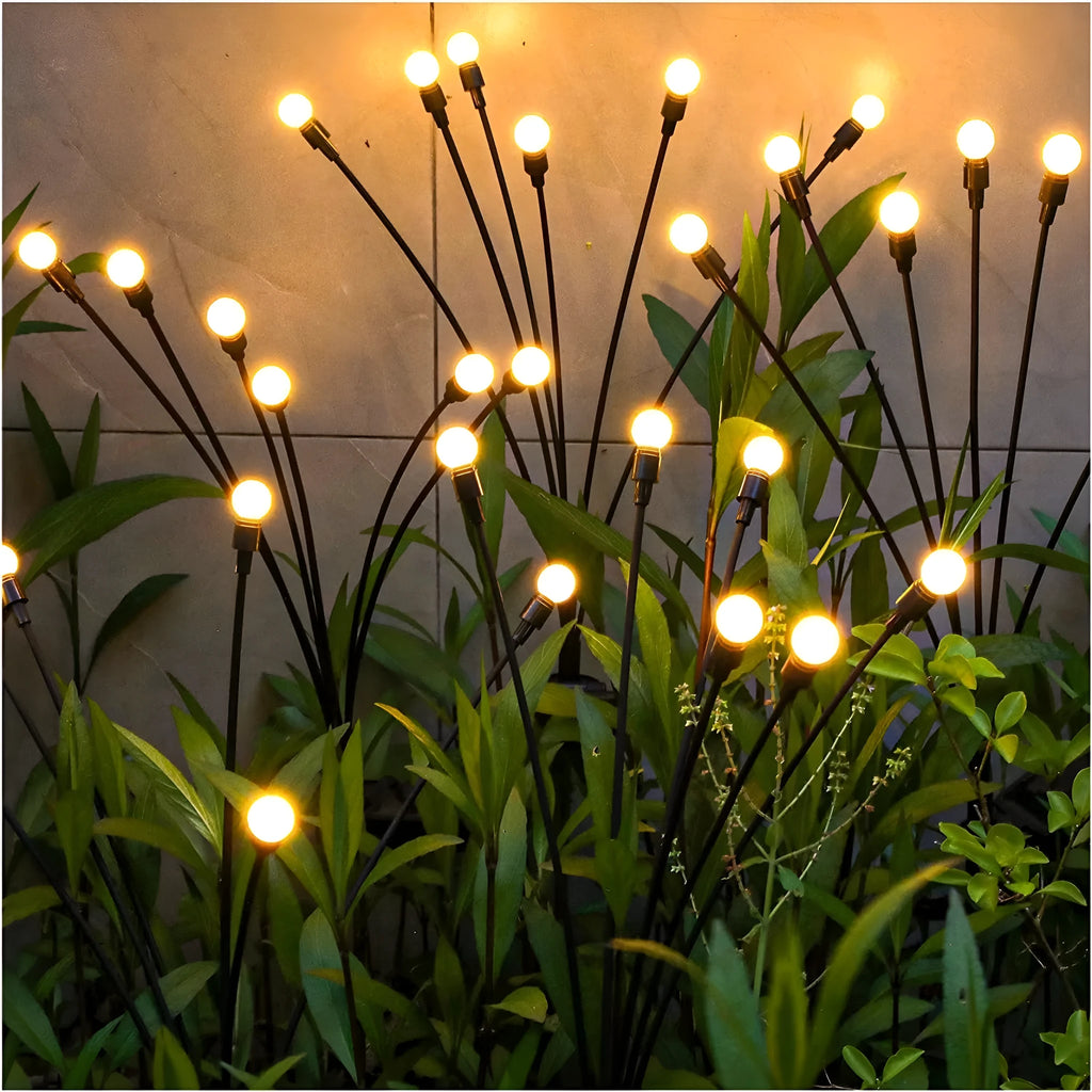 Solar-powered LED garden light with multiple heads on stainless steel ground spikes