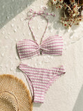 Women's pink and black striped printed bikini swimsuit on a hanger.