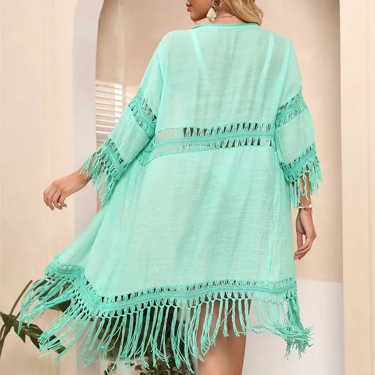 Yellow hand crocheted women's cardigan with tassel detail, a loose beach cover-up.