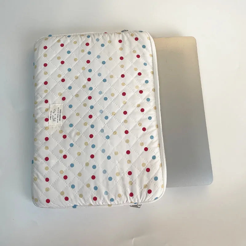 Women's polka dot polyester laptop bag shown in solid colour with size options for 11-inch to 15.6-inch laptops.