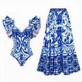 Women's printed one-piece swimsuit set with a matching cover-up skirt on a blue background.