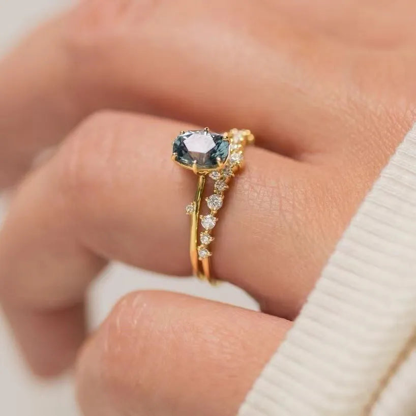 Gold plated women's ring with a green zircon stone set in a flower-shaped alloy band.