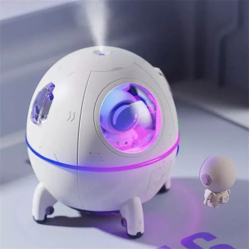 Astronaut-shaped portable USB humidifier with LED light on a desk