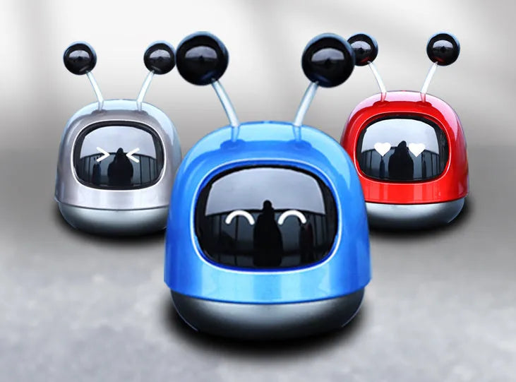 Robot-shaped car vent clip air freshener with aromatherapy gel in blue, grey, or red colour options.