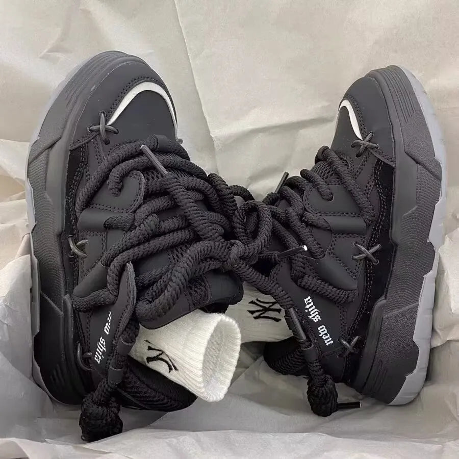 Women's black retro chunky sneakers with thick rubber platform sole and front lace-up.