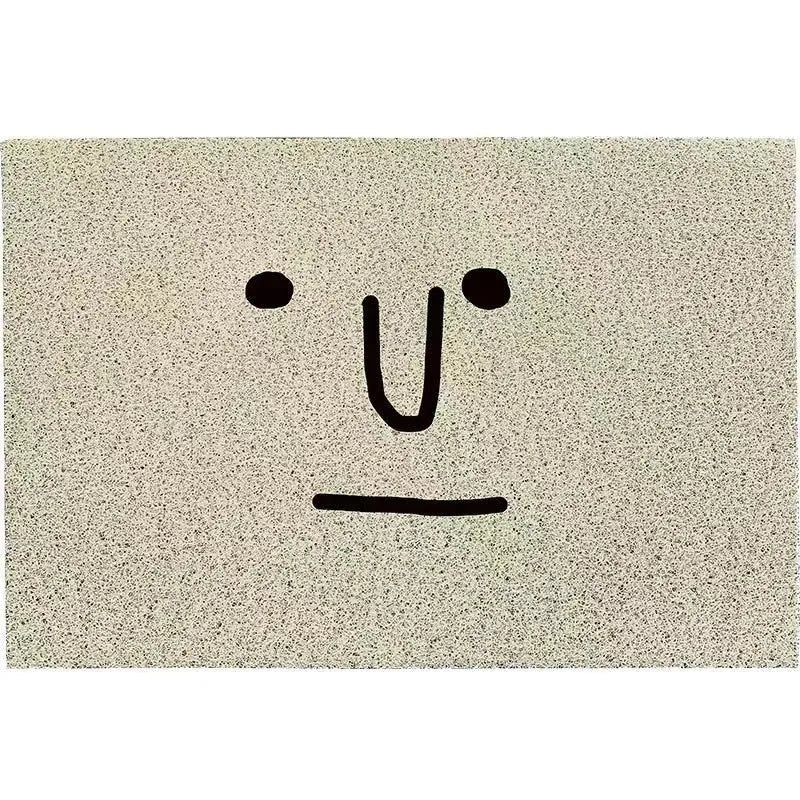 Square PVC home floor mat with a geometric pattern and cartoon Mr. Big Nose facial expression.