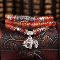 Handmade bracelet with geometric watermelon crystal beads and a Chinese knot closure.