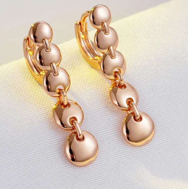 A pair of gold retro woven copper large circle hoop earrings.