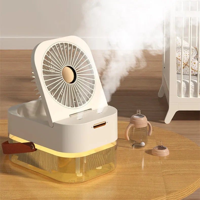 Pearl white portable USB desk fan with humidifier mist and soft night light on a wooden desk.