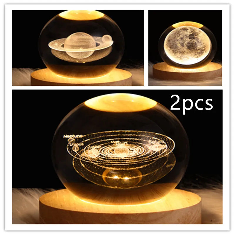 LED galaxy crystal ball night light with 3D planet designs on a table