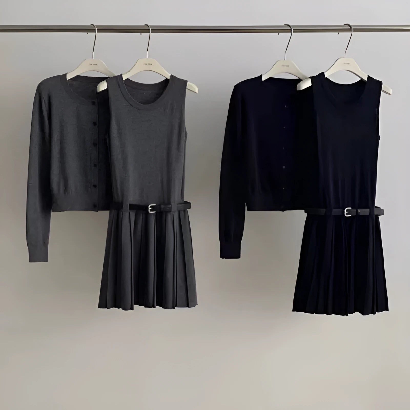 Women's black art retro knitted two-piece set with long-sleeve cardigan, pleated vest skirt, and a belt.