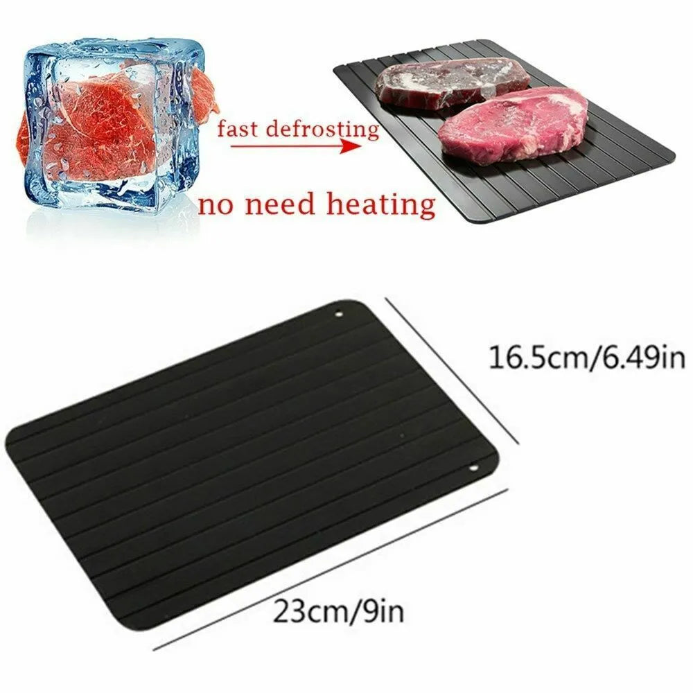 Black rectangular aluminium fast defrost tray for thawing frozen food on a kitchen counter.
