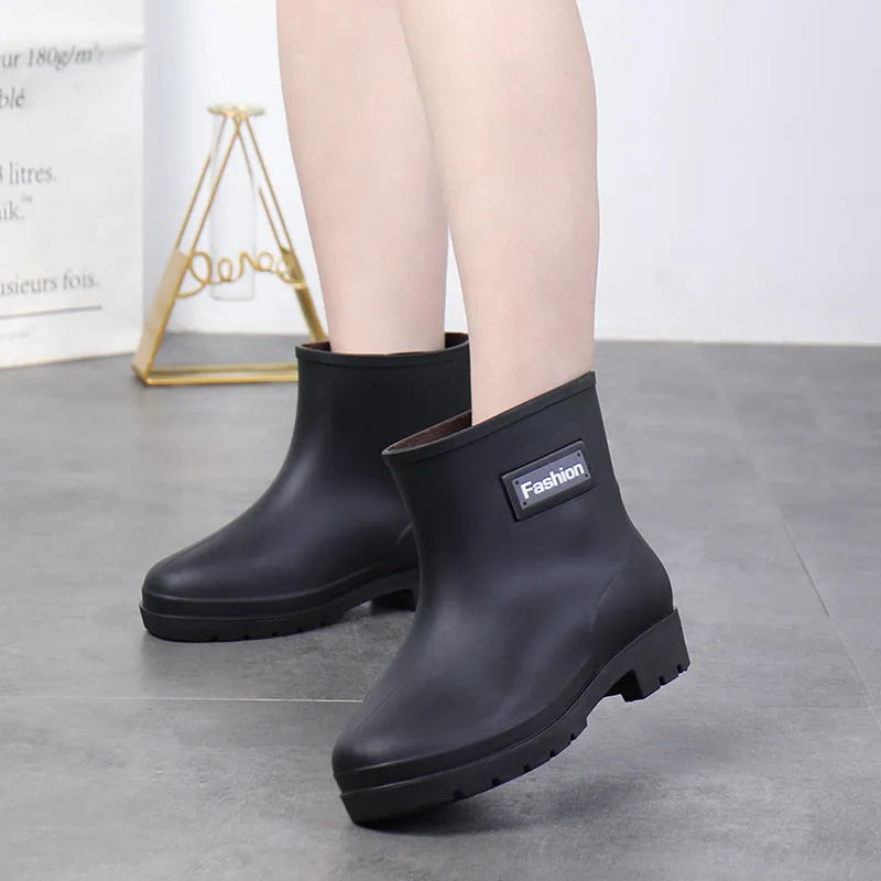 Women's mid-calf PVC rain boots in black, shown with a low heel and optional warm lining.