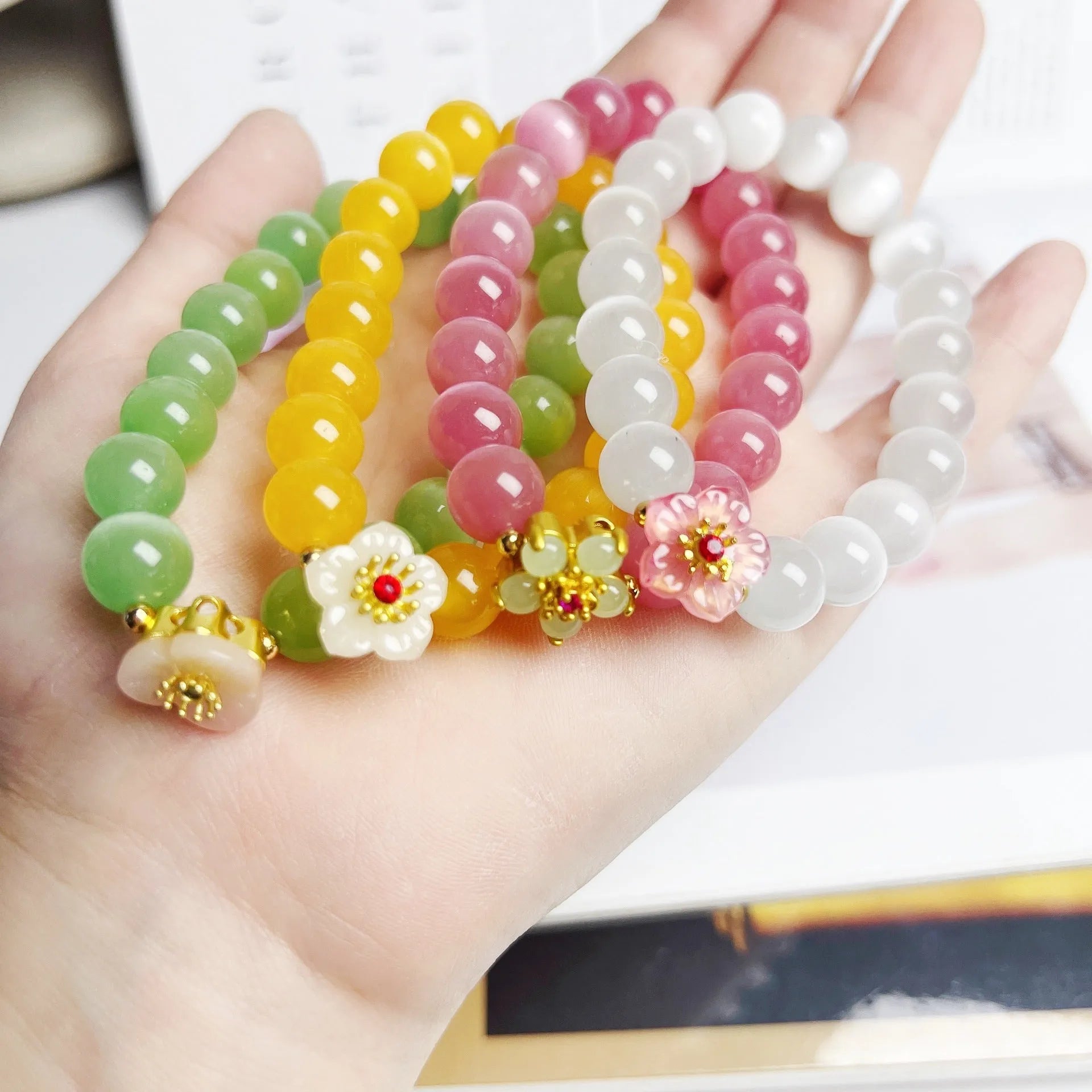 Handmade women's glass beaded bracelet with floral elements in yellow, pink, white, or green options