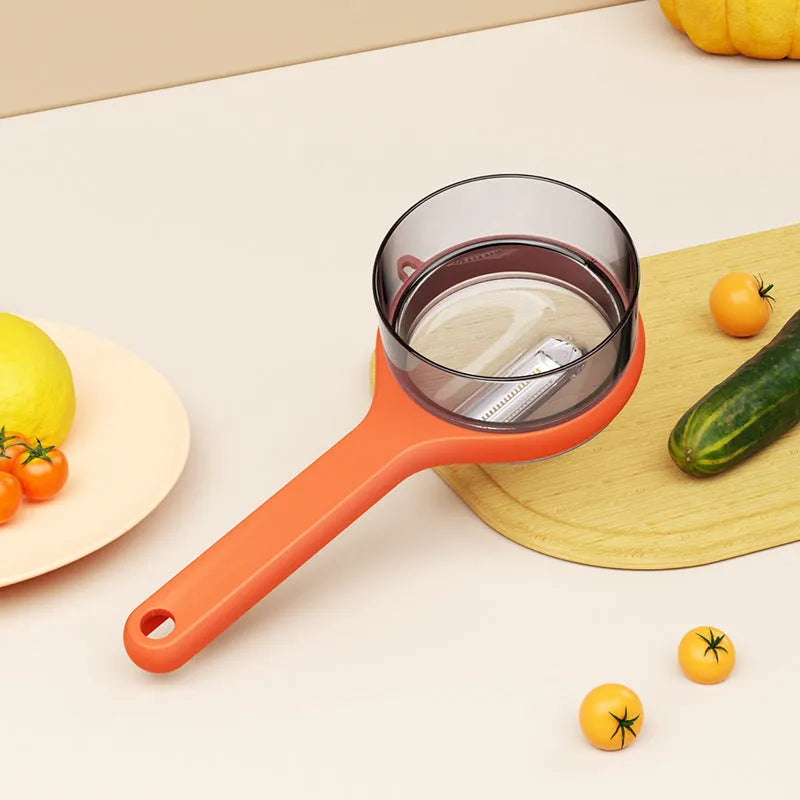 Light green plastic kitchen peeler with built-in storage bucket and scraper function.