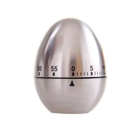 Egg-shaped stainless steel mechanical kitchen timer on a kitchen countertop.
