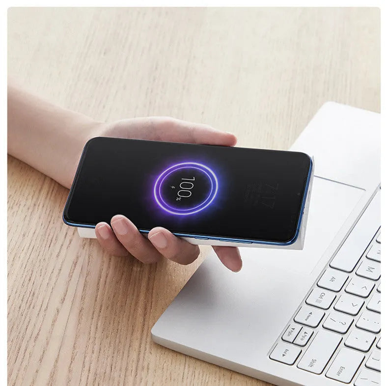 White 10000mAh power bank showing USB Type-C port, USB output, and wireless charging symbol.