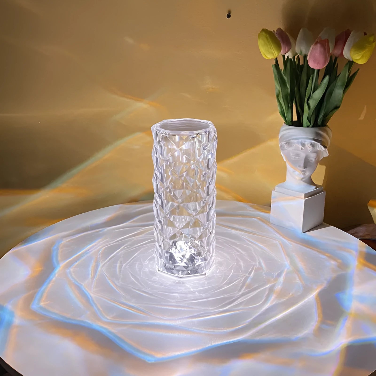 Creative acrylic crystal rose LED table lamp with adjustable three-colour lighting on a wooden surface.
