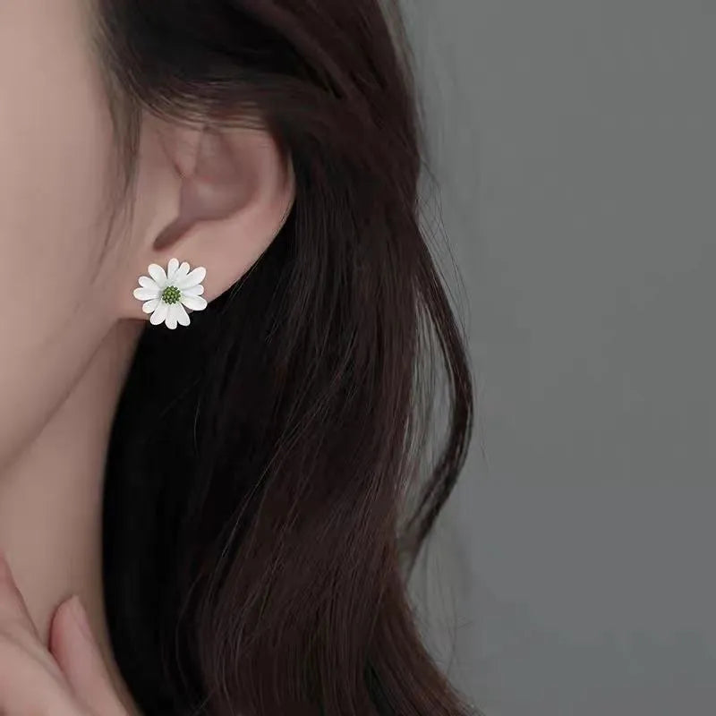Close-up of colourful cartoon flower stud earrings in alloy on a white background.