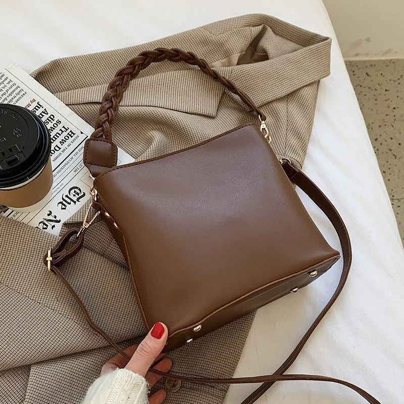 Retro style woven PU one-shoulder crossbody bucket bag in khaki colour.