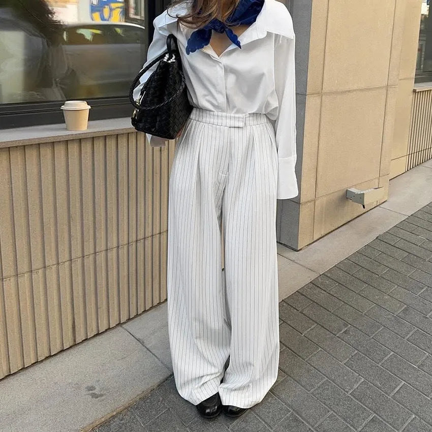 White striped loose fit wide-leg casual trousers with a zipper, shown on a hanger.