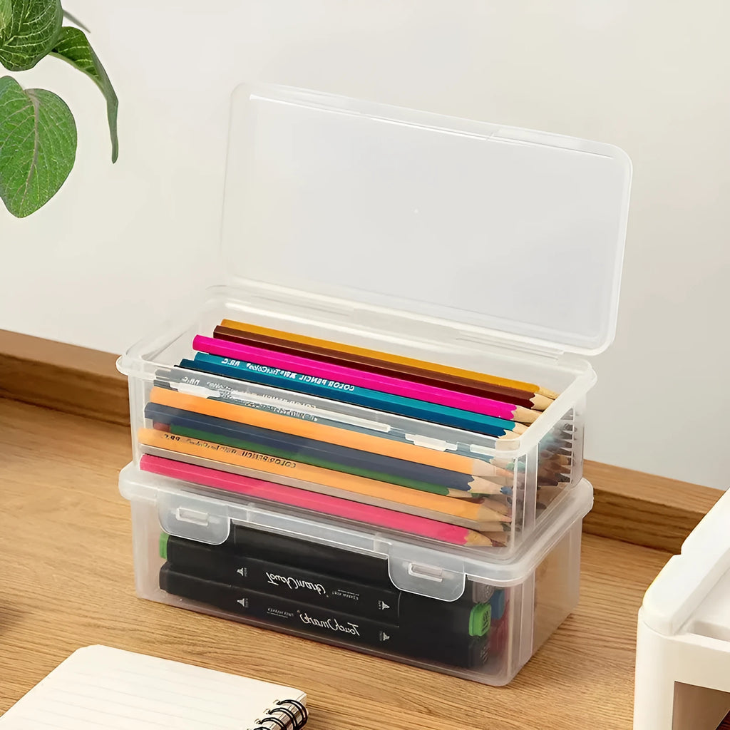 Clear plastic stationery storage box filled with assorted coloured pencils and crayons.