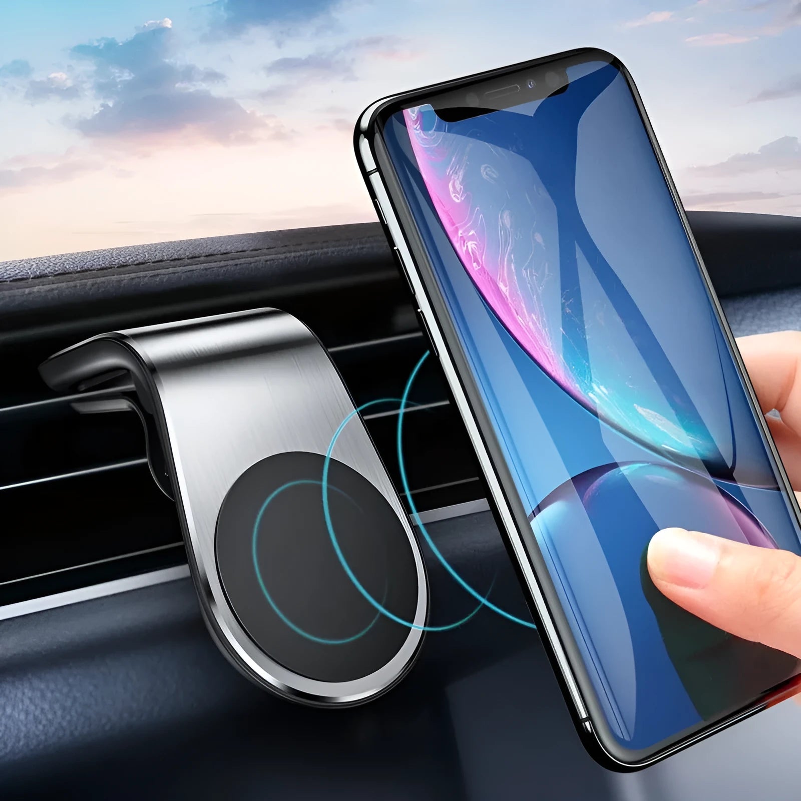 Car phone bracket mounted on vehicle air vent in silver finish showing rotation adjustment