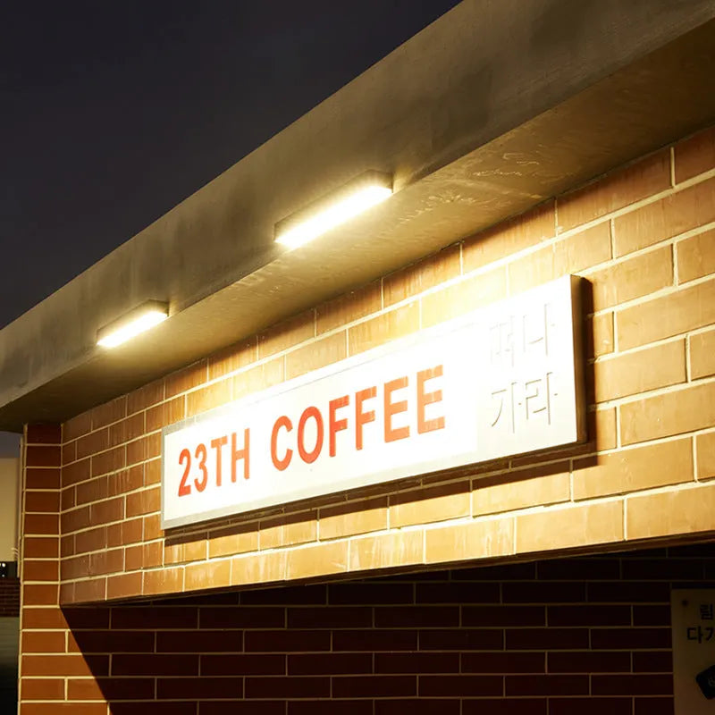 Black ABS plastic solar-powered outdoor wall strip light with IP65 rating.
