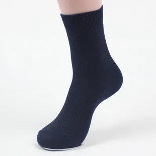 Men's bamboo fibre business socks in grey with a small-square pattern, shown on a foot.