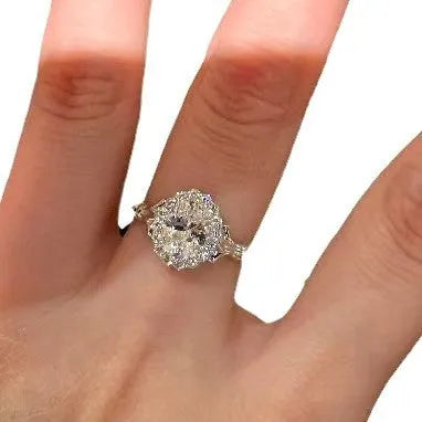 Silver-coloured geometric ring with ellipse detail and adjustable opening on a plain background.