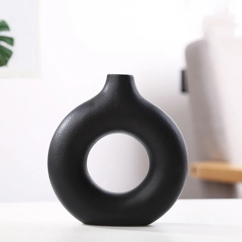 Frosted unglazed porcelain biscuit vase in a simple modern style on a table.
